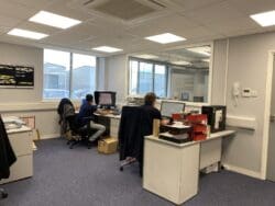 Warehouse office design with glazed window and furniture.