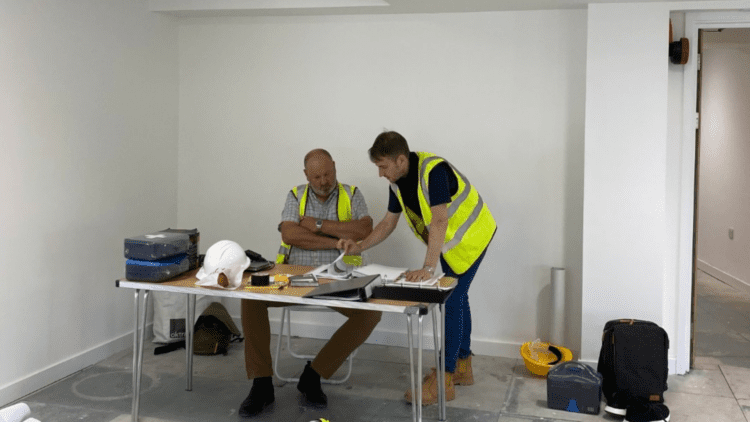 Principal contractor site meeting with site manager on an office refurbishment project.