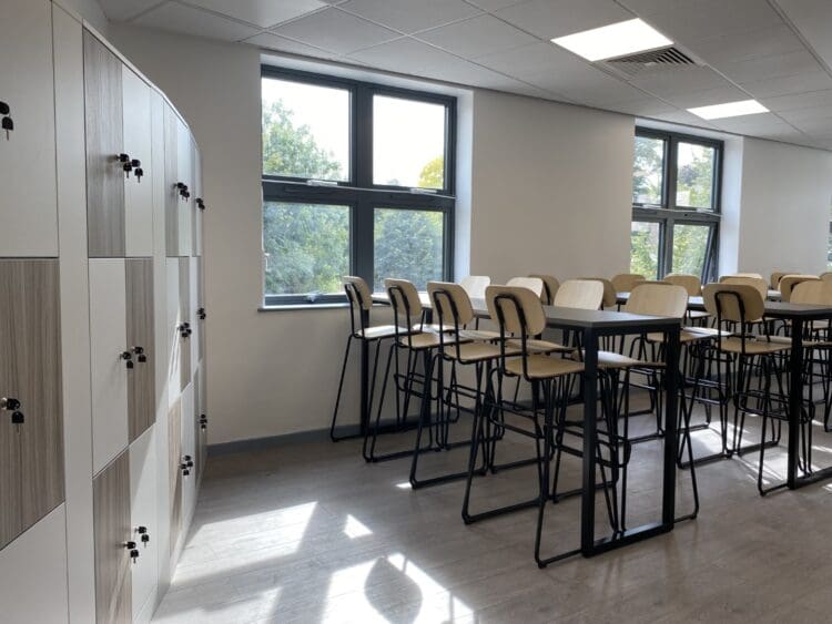 Dining tables and high curved stools in school refurbishment project.