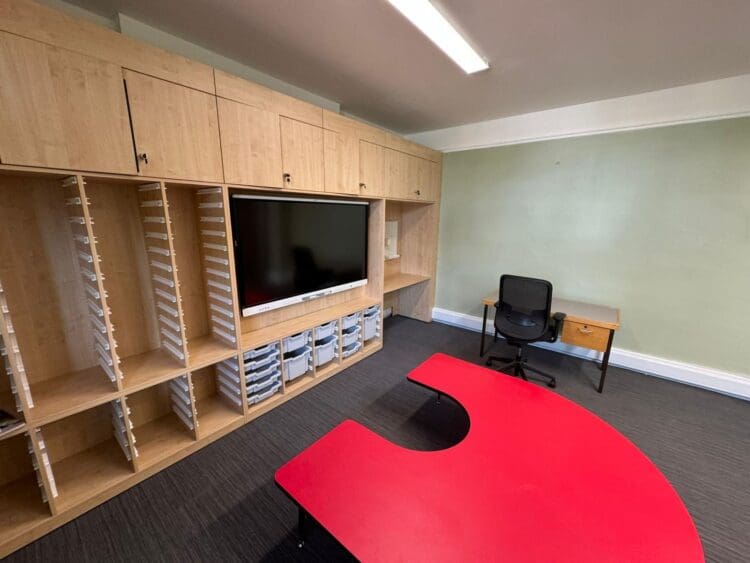Bespoke media wall with integrated TV and storage for school refurbishment