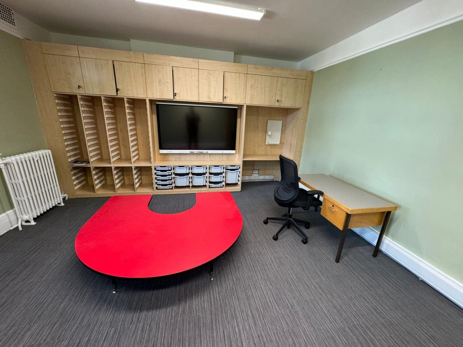 SEND classroom design and refurbishment with bespoke teaching wall and calming green walls.
