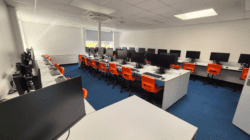 Modern school refurbishment with orange chairs and modern desks.