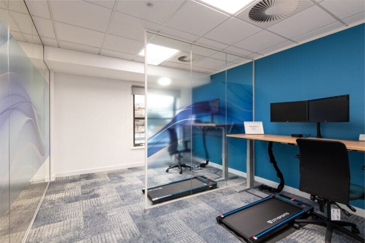 Active zone in office fit out including walking pads and height adjustable desks.