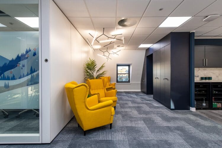 Event space in office interior design scheme with soft seating and storage wall.