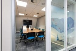 Executive office meeting room with glazed operable wall.