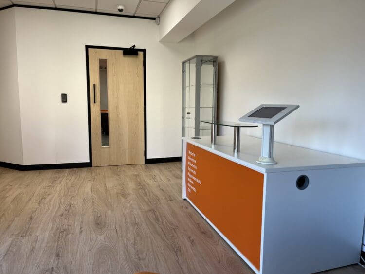 Office reception area refurbishment with branded reception desk.