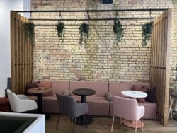 Banquet seating with arm charis creating a breakout space design at Pledge furniture showroom.