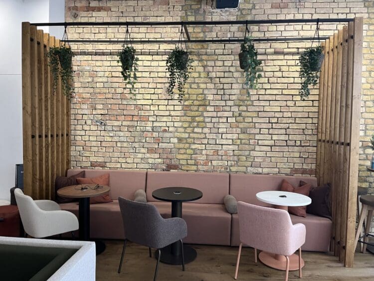 Banquet seating with arm charis creating a breakout space design at Pledge furniture showroom.