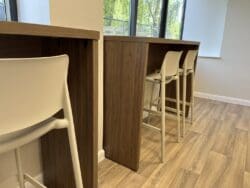 Modern wood effect breakfast bar with poseur height stools.