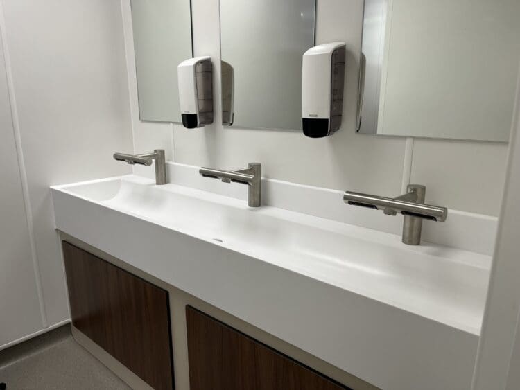 Office washroom refurbishment kent with sleek modern sinks and stainless steel taps.