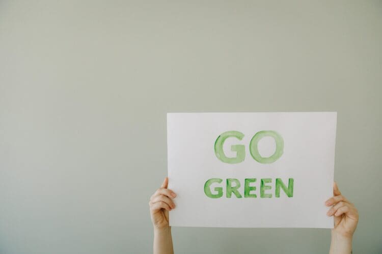 Go Green sign promoting sustainability and eco conscious ideals for workplace design.