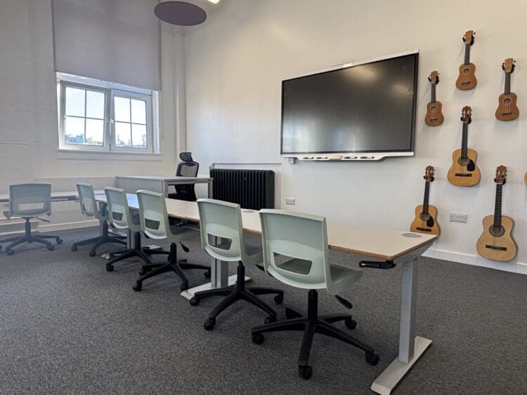 Modern school refurbishment with height adjustable desks.
