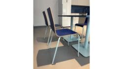 Dining chairs and table in office breakout space design.