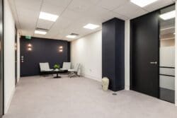London office interior design with soft seating in visitors waiting area.