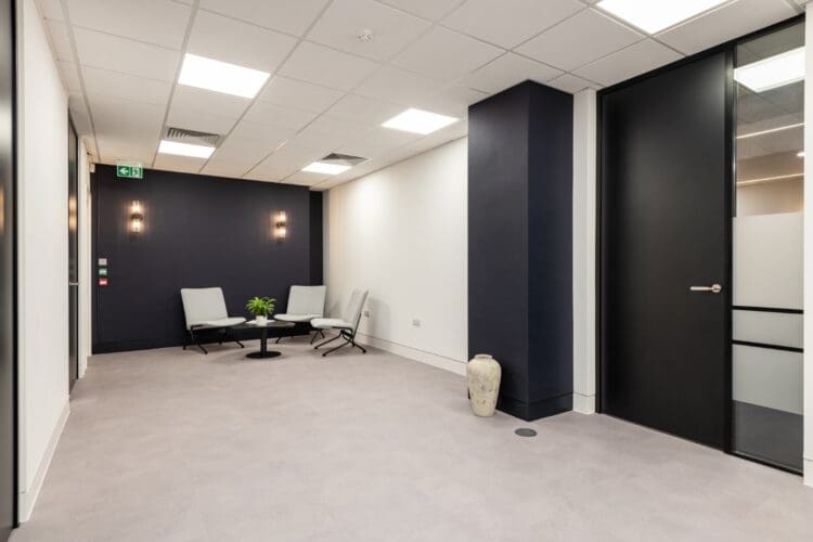 London office interior design with soft seating in visitors waiting area.