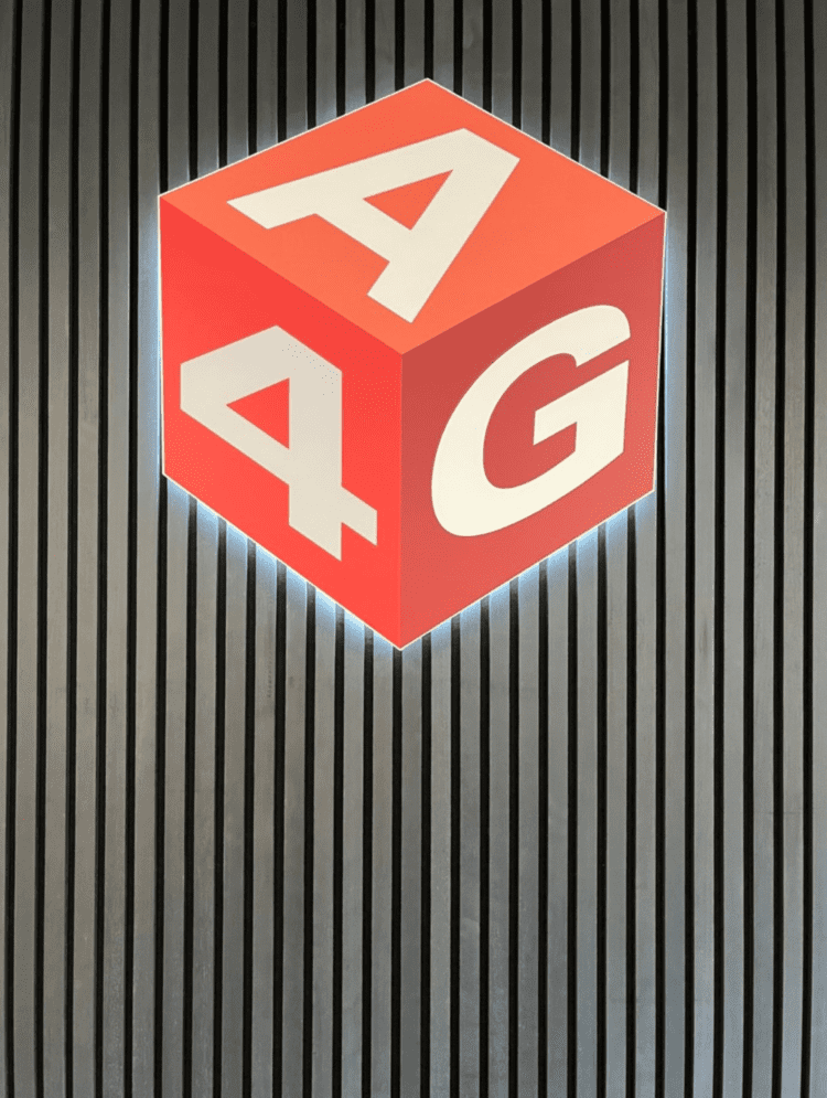 Backlit branded logo on office feature wall.