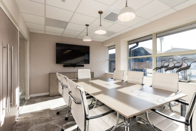 Modern office boardroom with feature lighting.