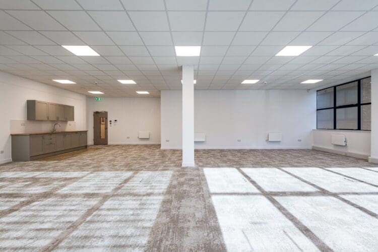 Office fit out for tennant leasing with neutral flooring.